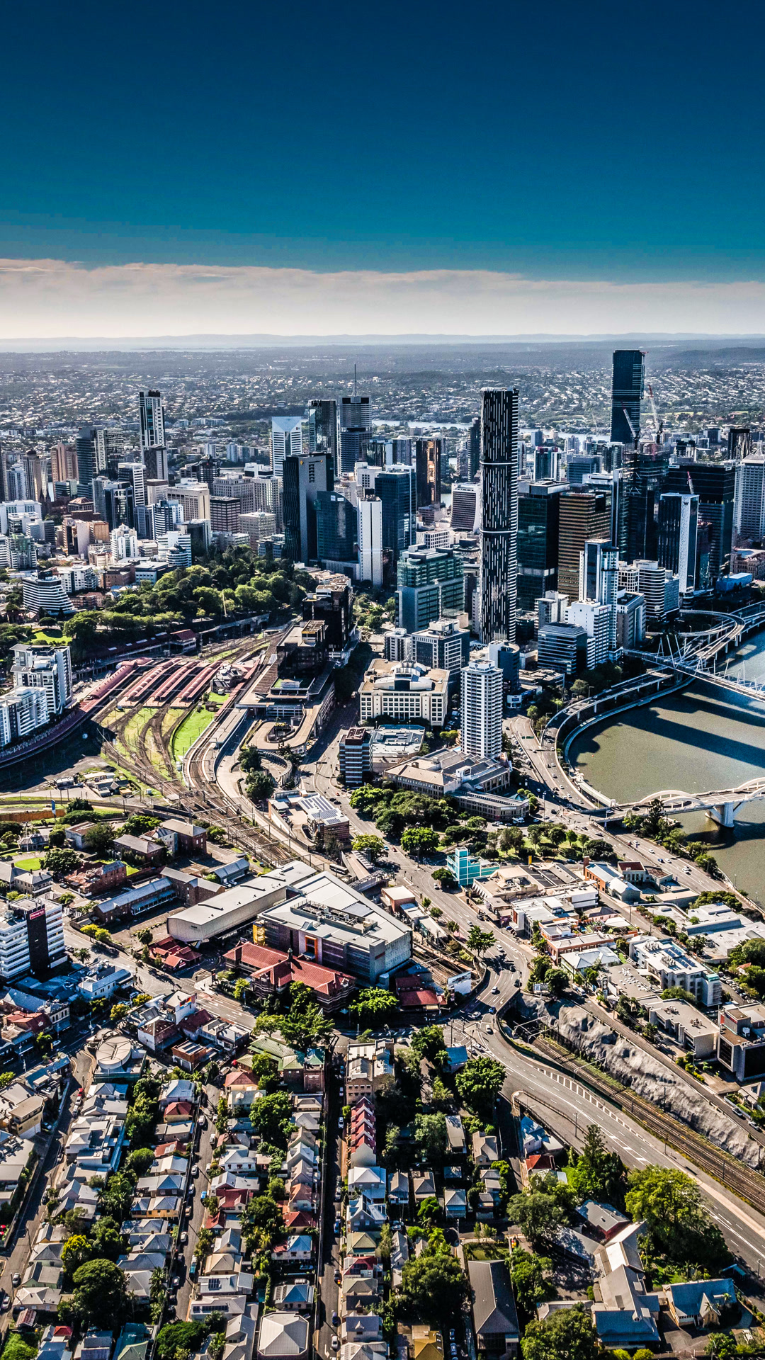 Aerial view of Brisbane city skyline and river.