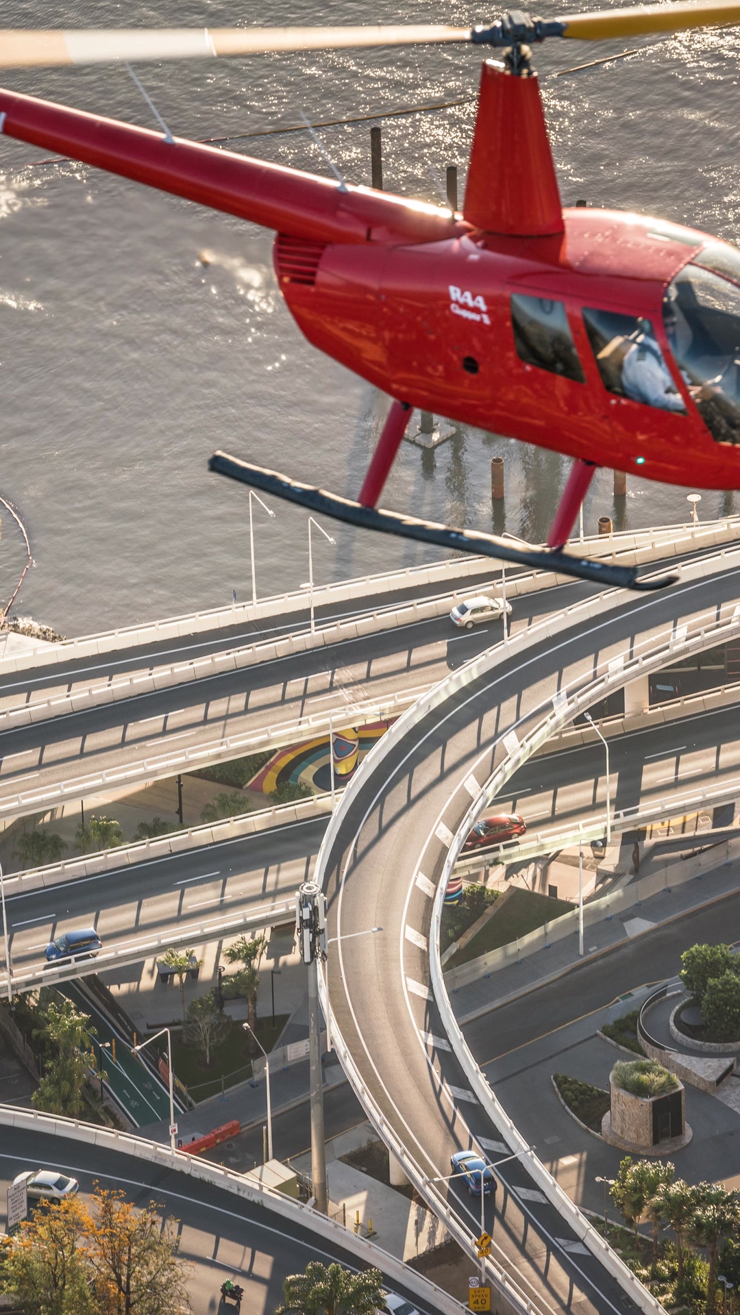 Red Bekaa Air helicopter above Brisbane river roads.