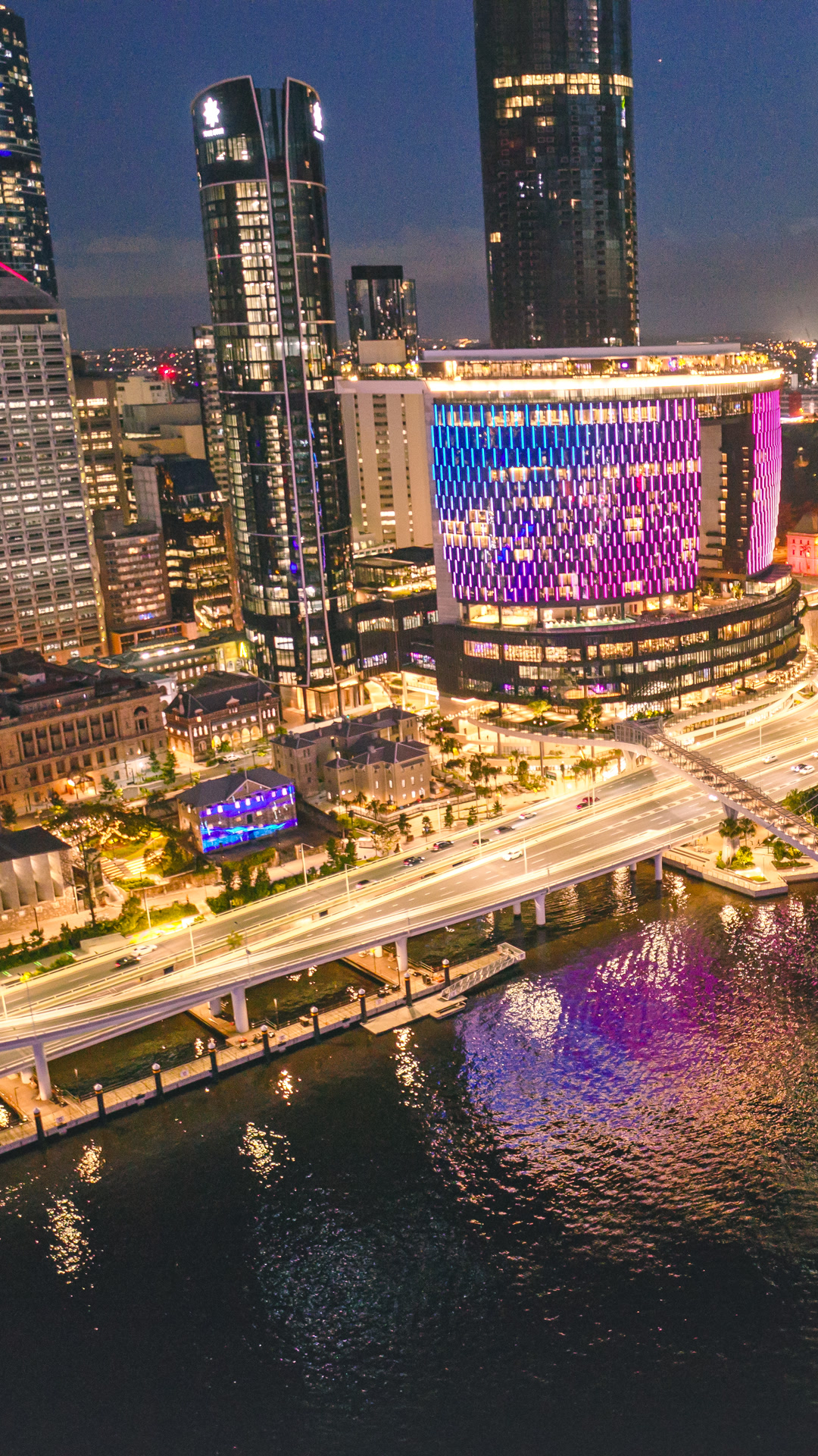 Brisbane city lights and Queens Wharf from above at night.