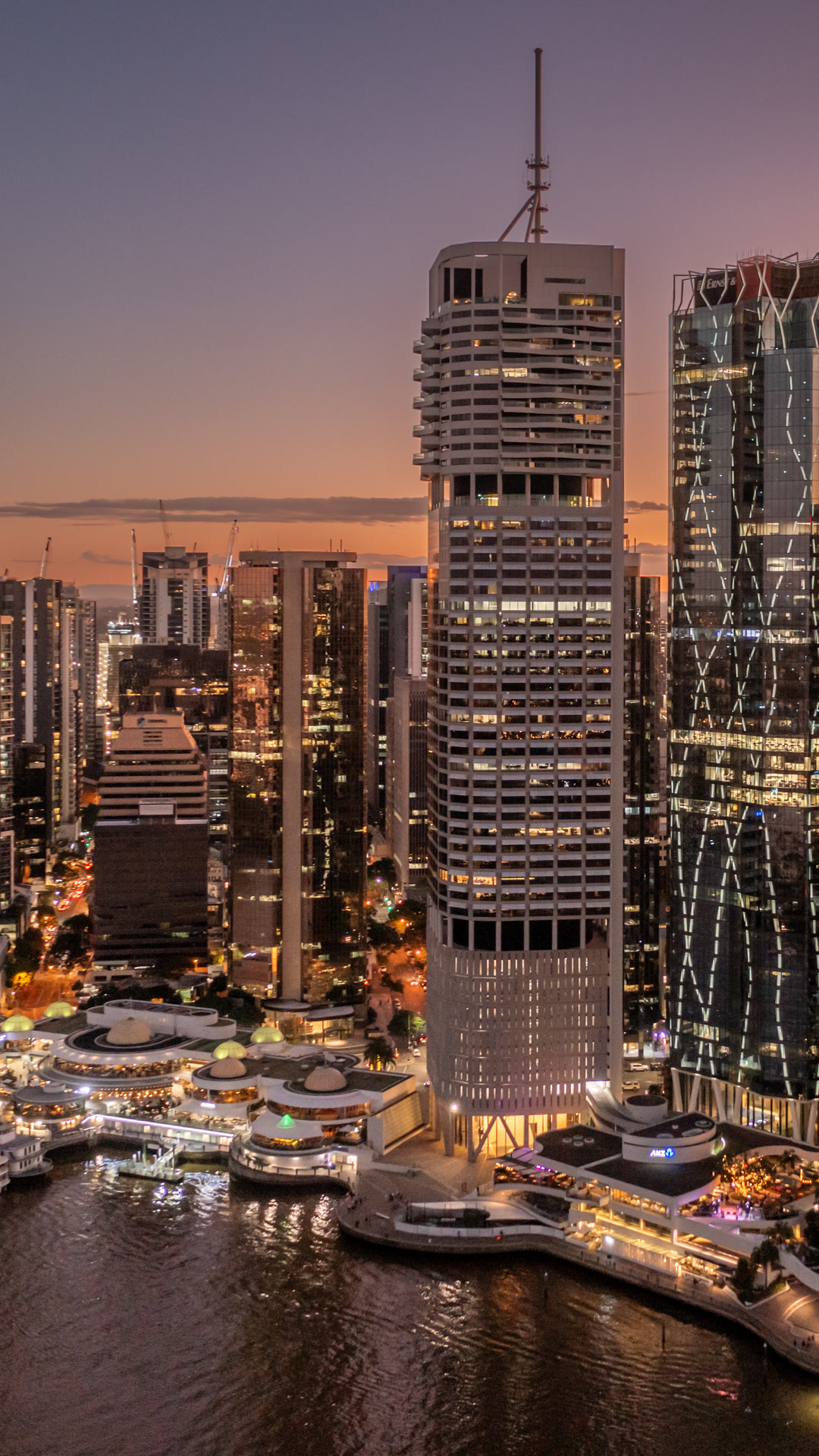Evening city view of buildings along the Brisbane River.