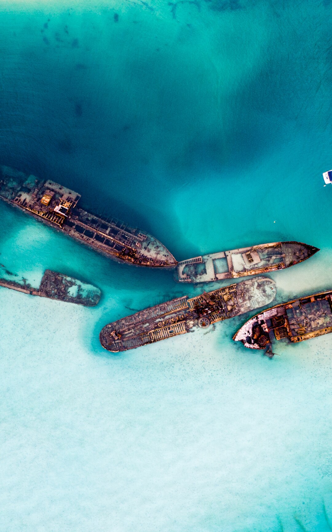 Tangalooma Wrecks in clear turquoise water from above.