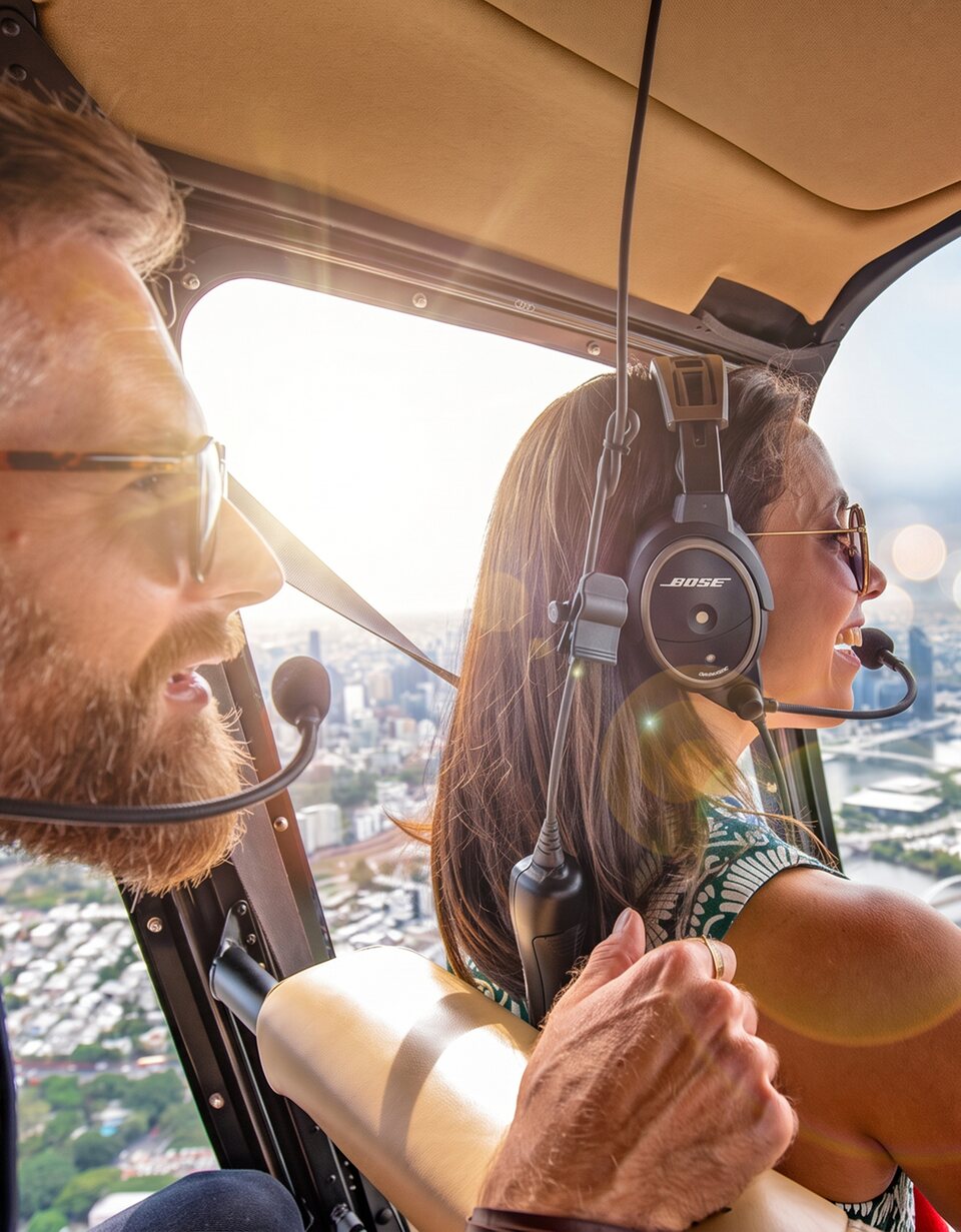 Couple taking in Brisbane from a Bekaa Air helicopter