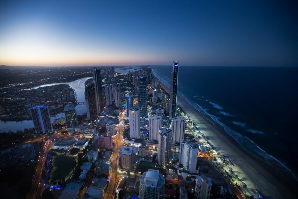 Gold Coast high-rises and coastline after dusk.