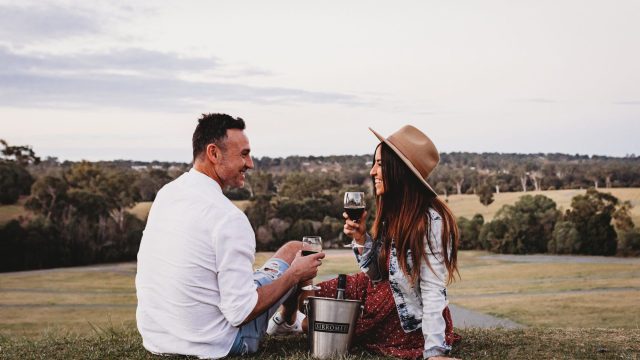 Sirromet a couple enjoy a picnic with some wine at Sirromet Wines