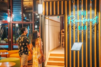 Couple walking into The Rainforest Bar