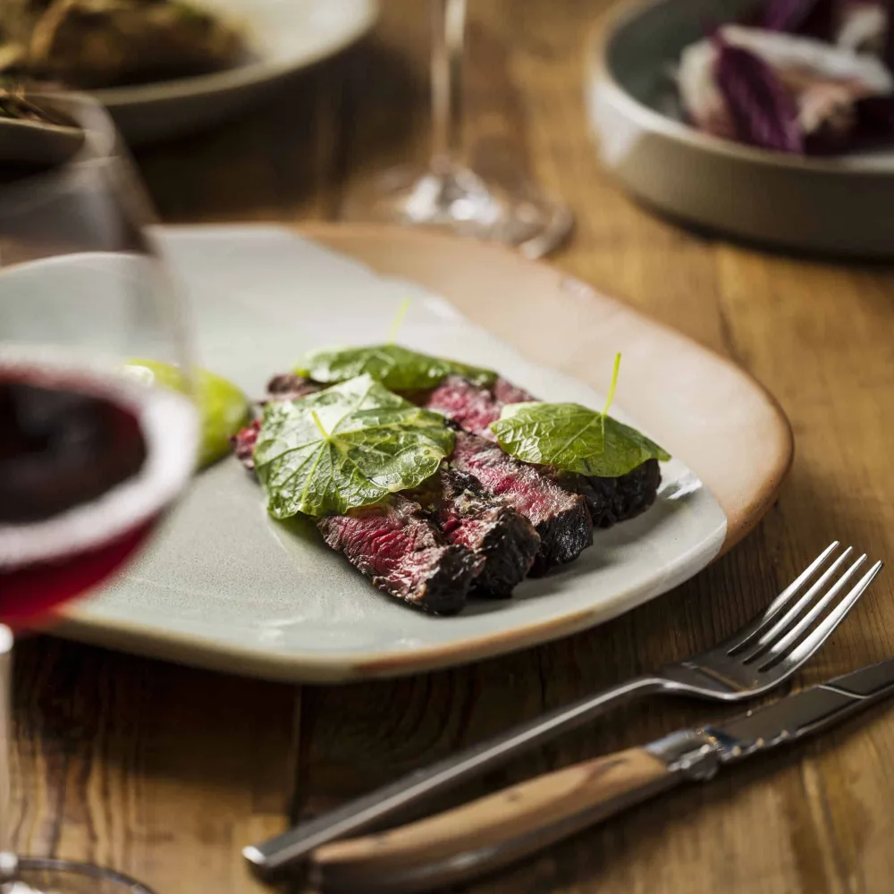 Beechmont Estate dining plate with red wine.