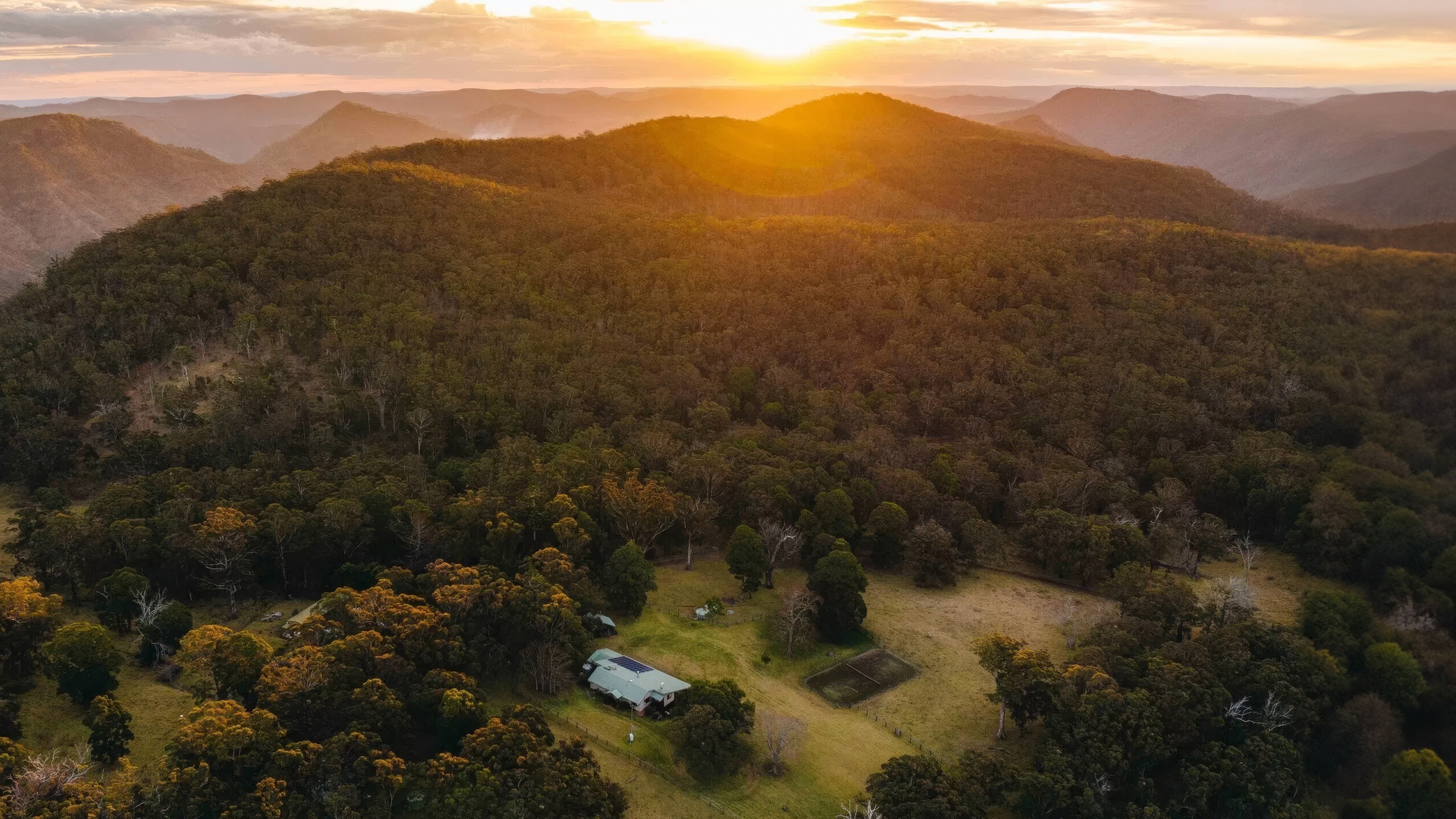 Mount Mistake farmhouse beneath the Scenic Rim at sunset.
