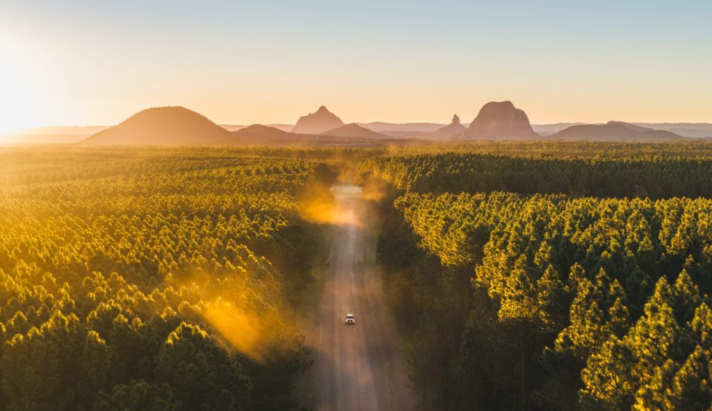 Aerial view across the Glass House Mountains and surrounding forest.