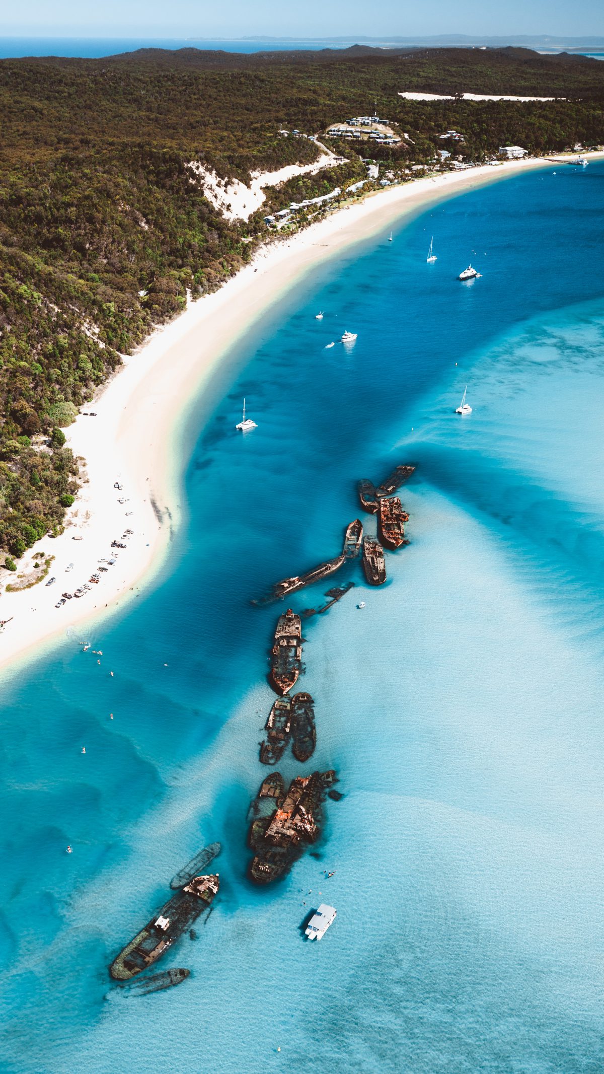 Aerial view of Tangalooma Wrecks and turquoise water.