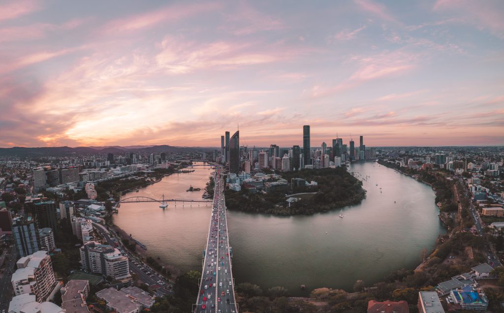 Brisbane city and river at sunrise from above.