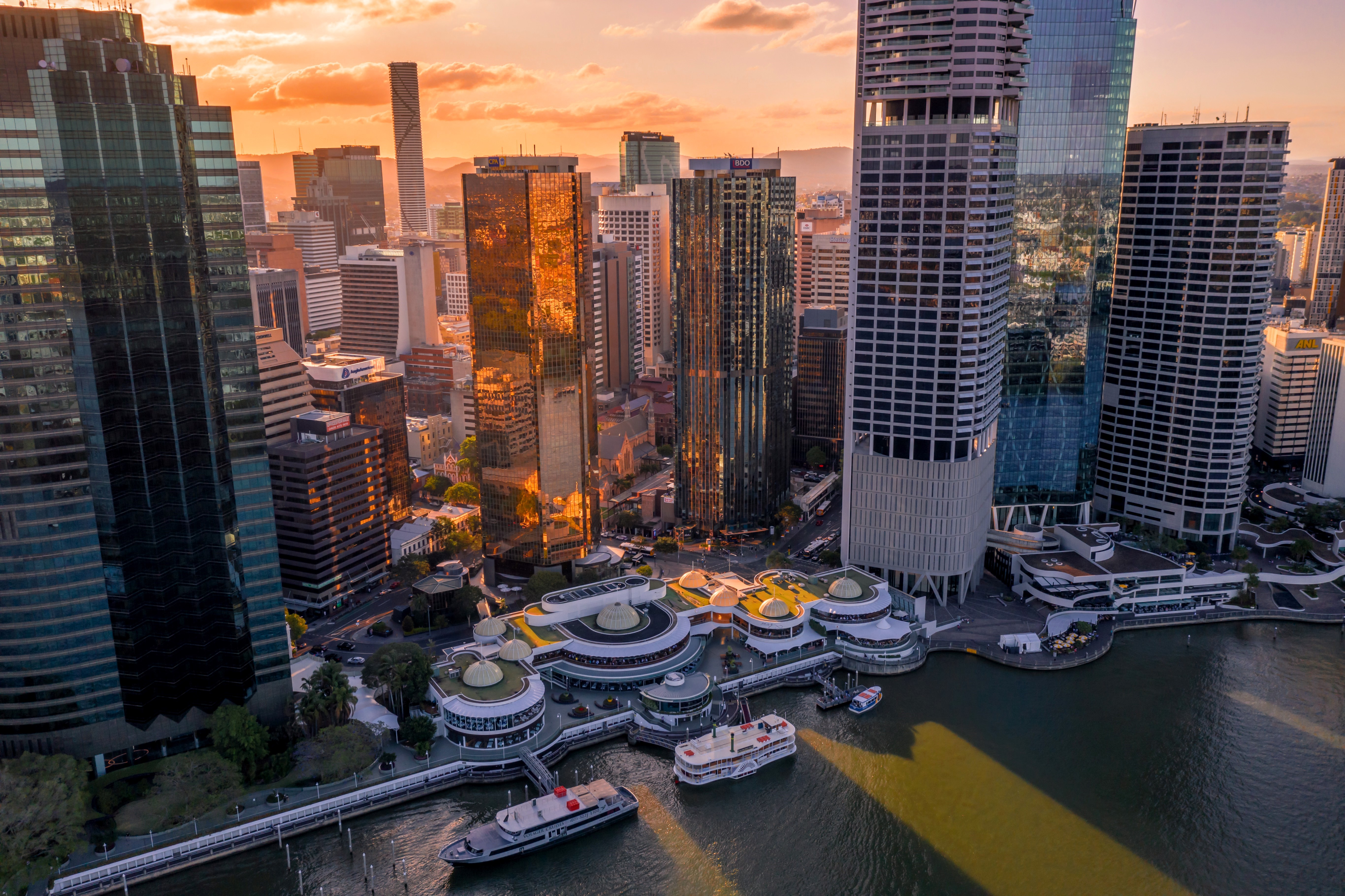 Aerial view of Brisbane city and Eagle Street Pier at sunset