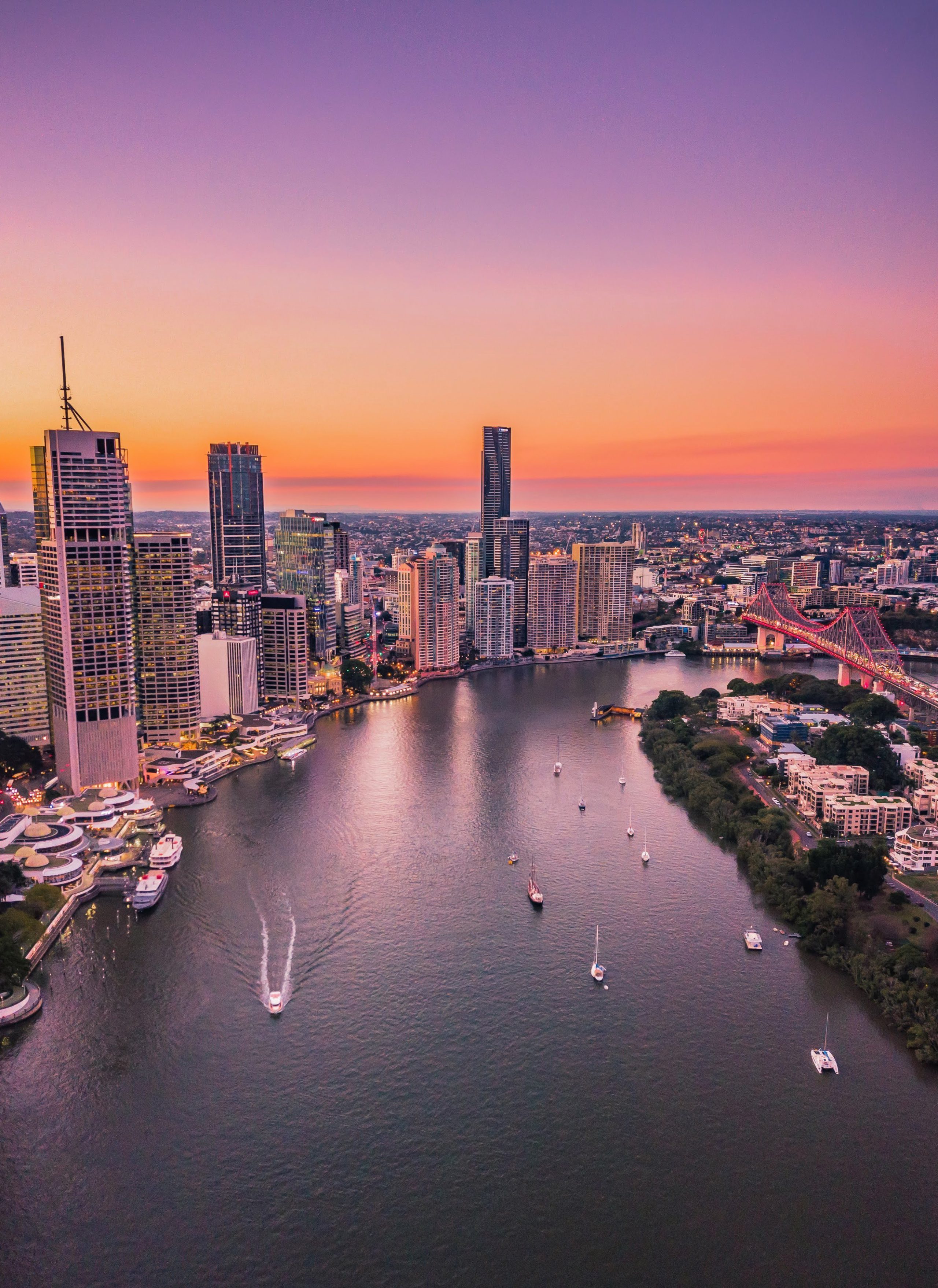 Aerial view of Brisbane River and cityscape at sunset