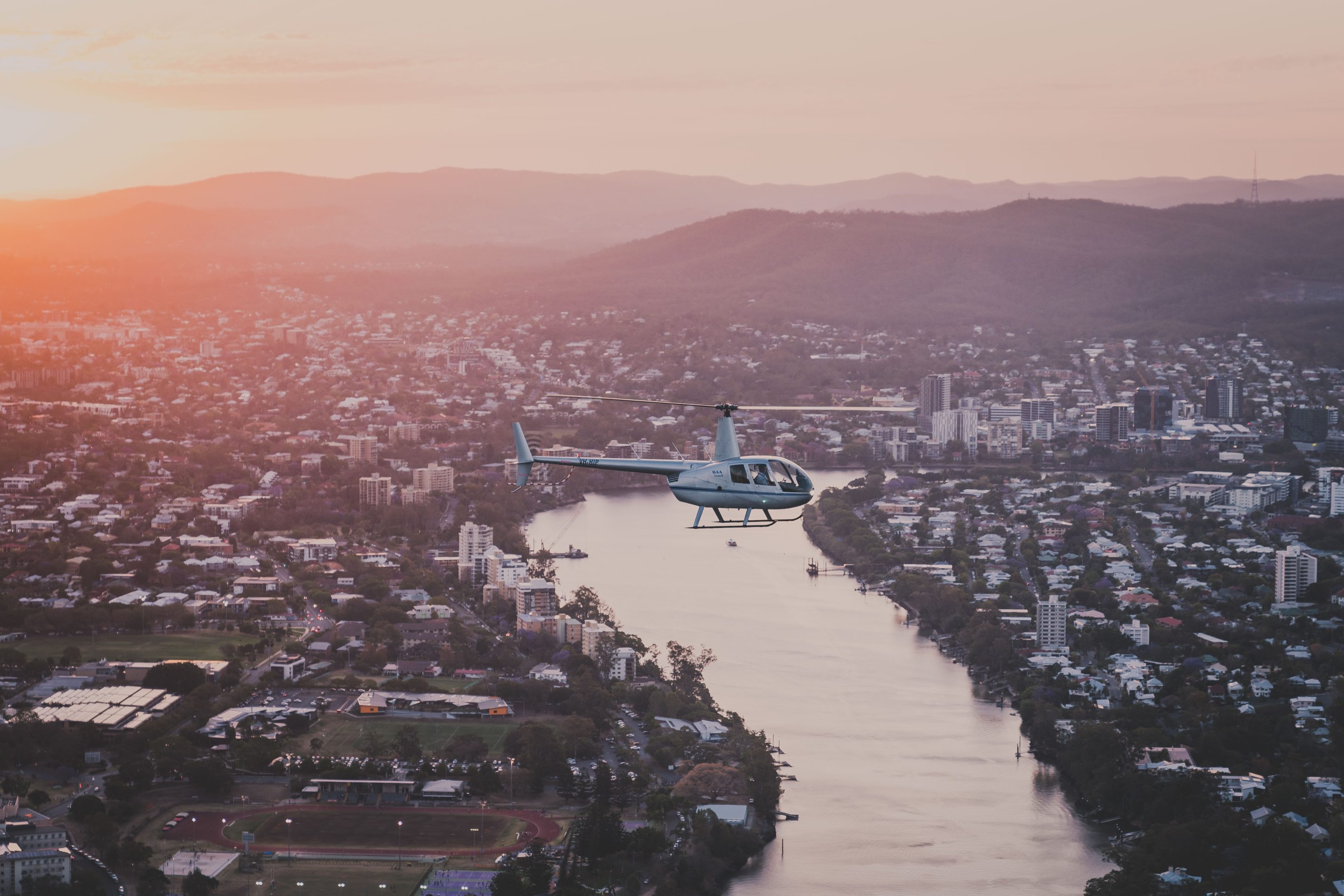 Helicopter above Brisbane River at sunrise