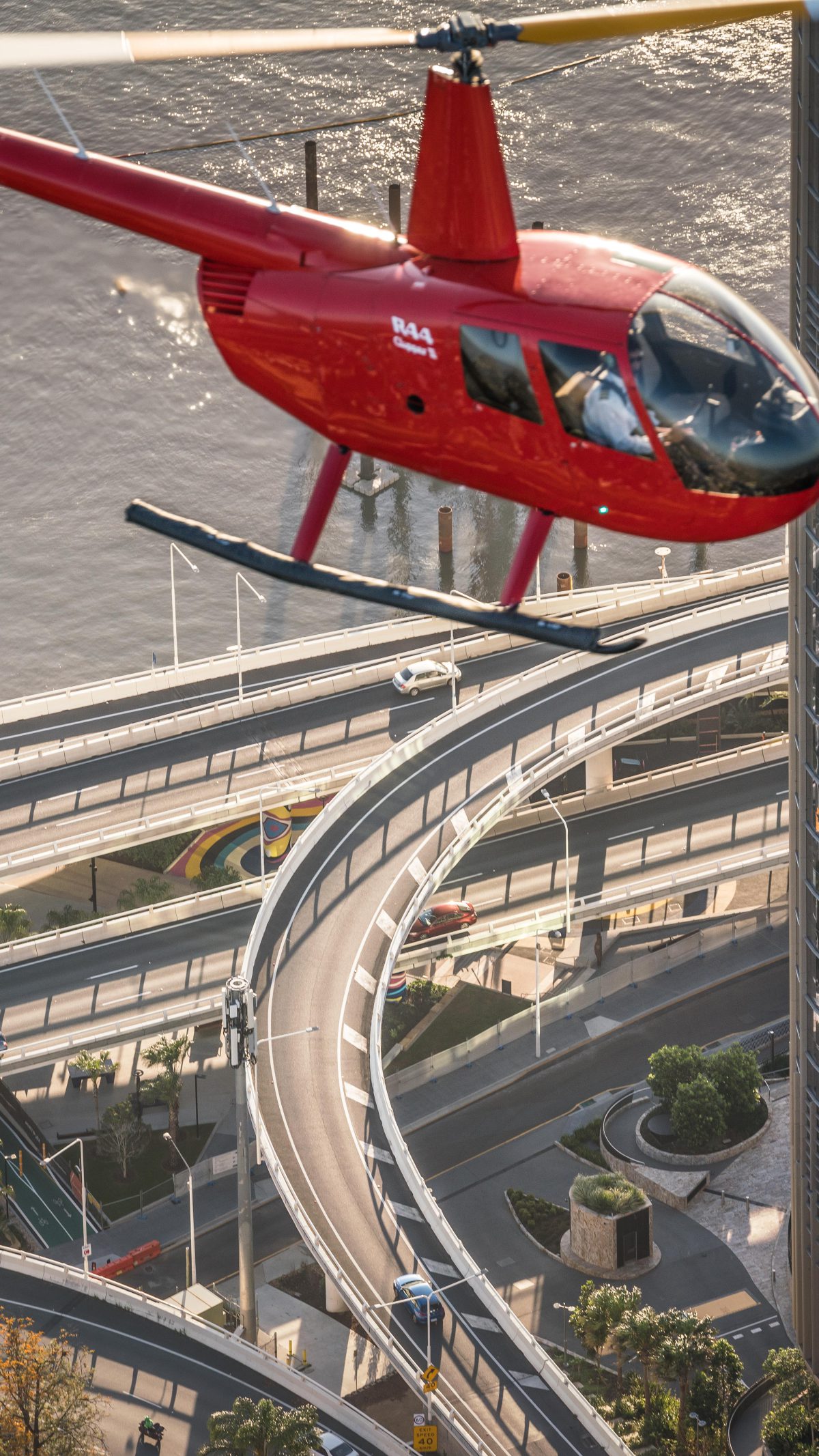 Red Bekaa Air helicopter over Brisbane river roads