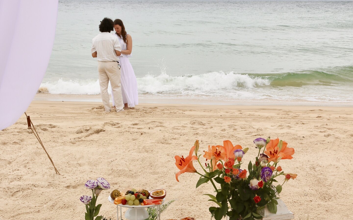 Proposal picnic arranged beside the ocean.
