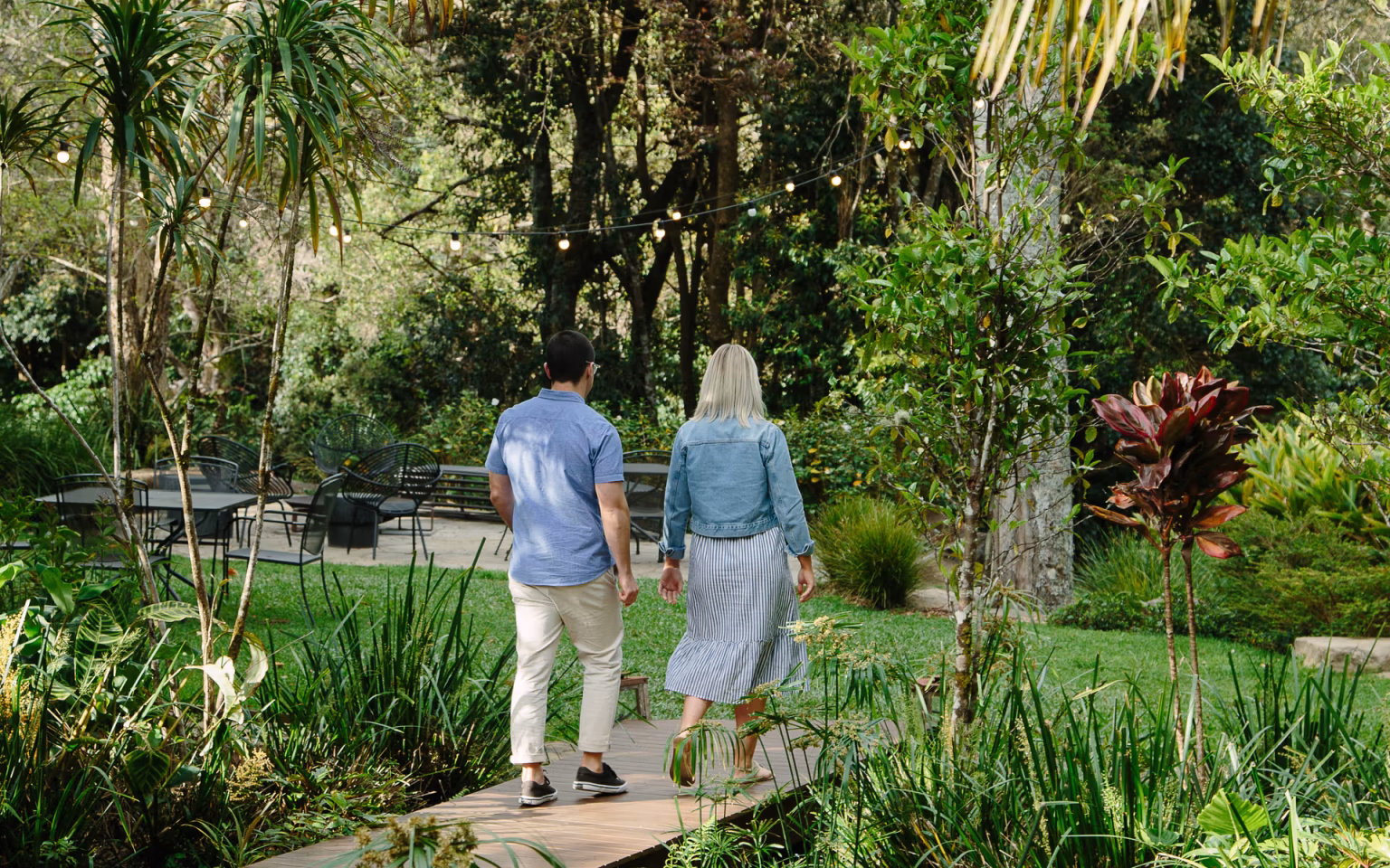 Guests walking through the rainforest garden at Spicers Tamarind.