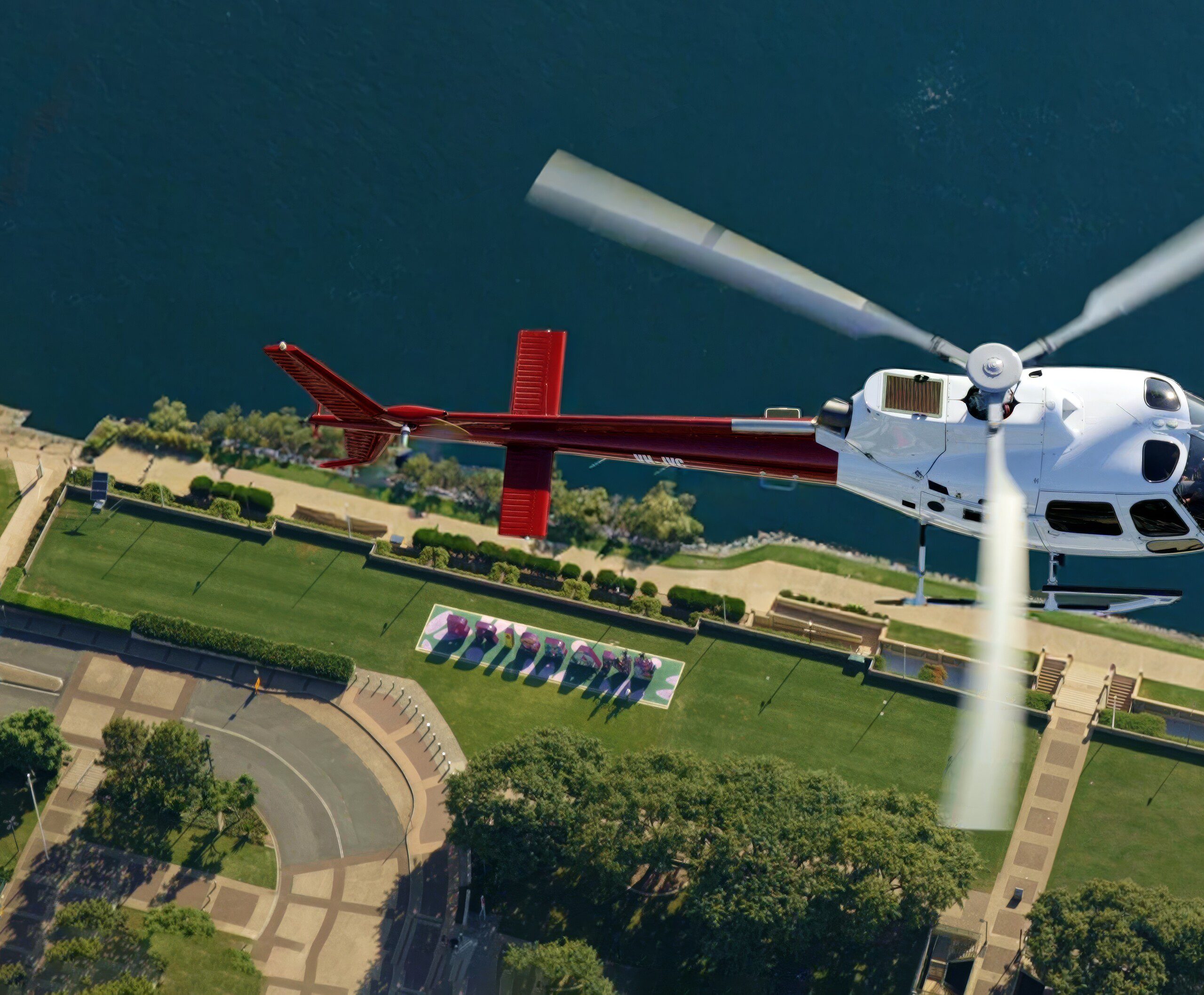 Bekaa Air helicopter flying above the Brisbane sign at South Bank