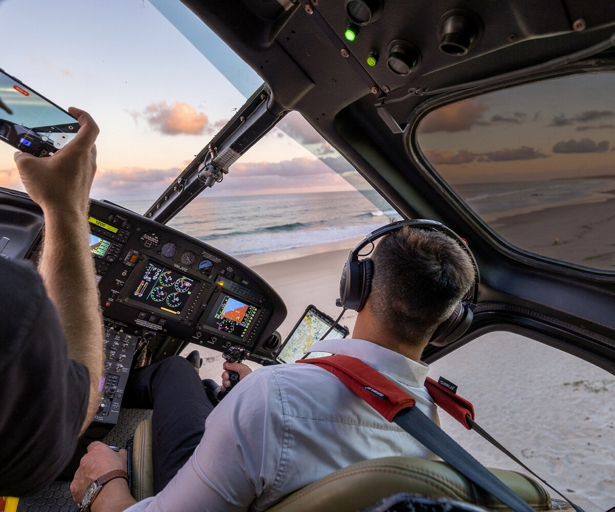 Helicopter cockpit over Moreton Bay coastline