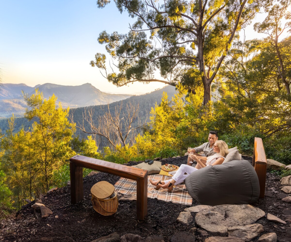 Couple enjoying a private mountain picnic overlooking the Scenic Rim