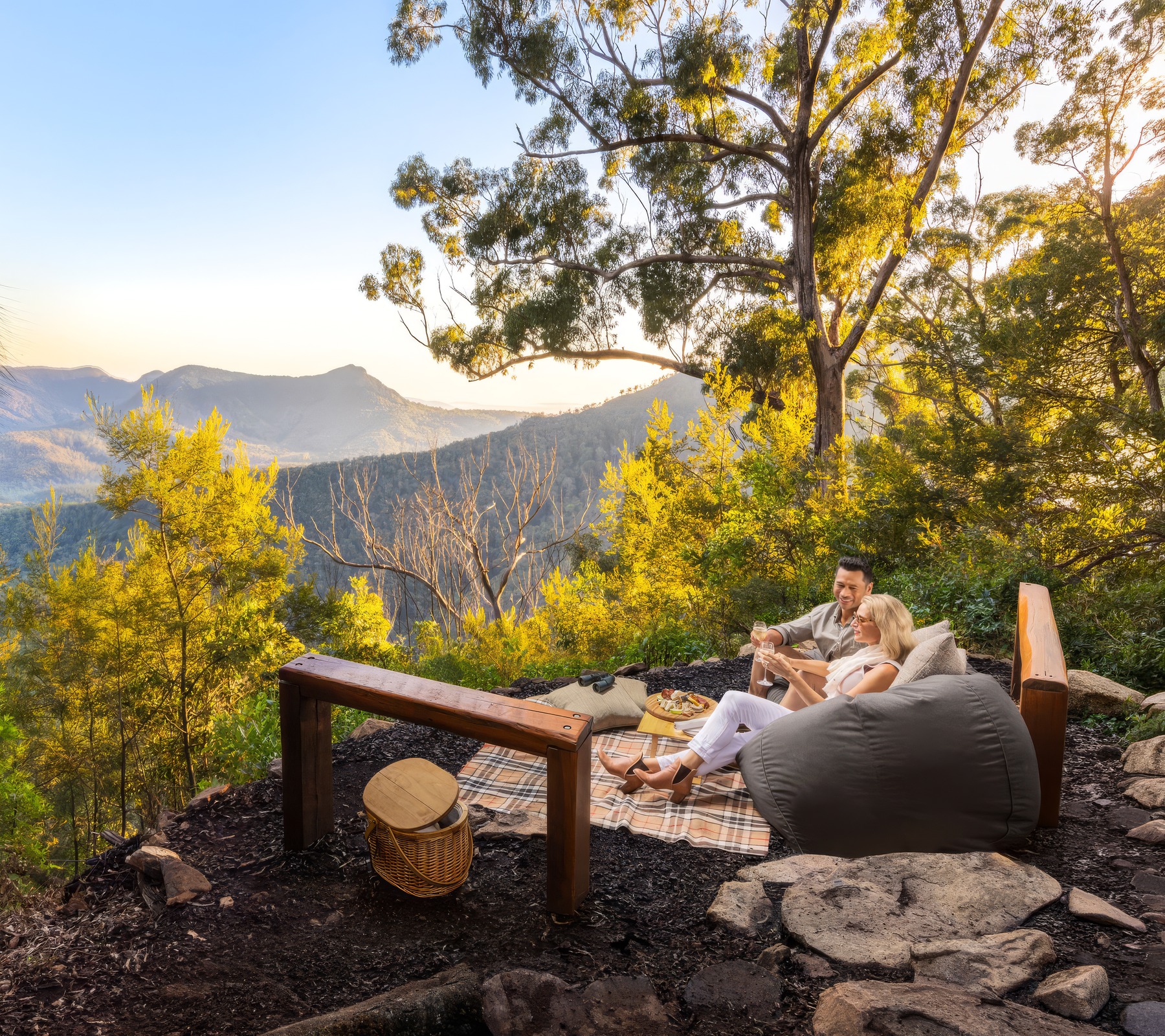 Couple enjoying a private mountain picnic overlooking the Scenic Rim