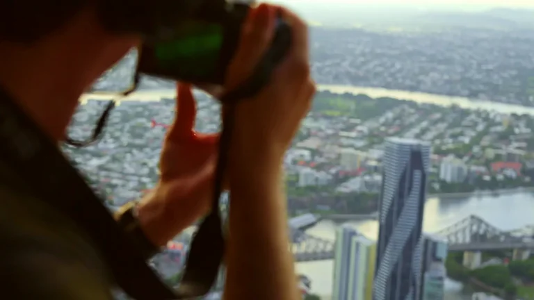 Photographer shooting from a helicopter over Brisbane
