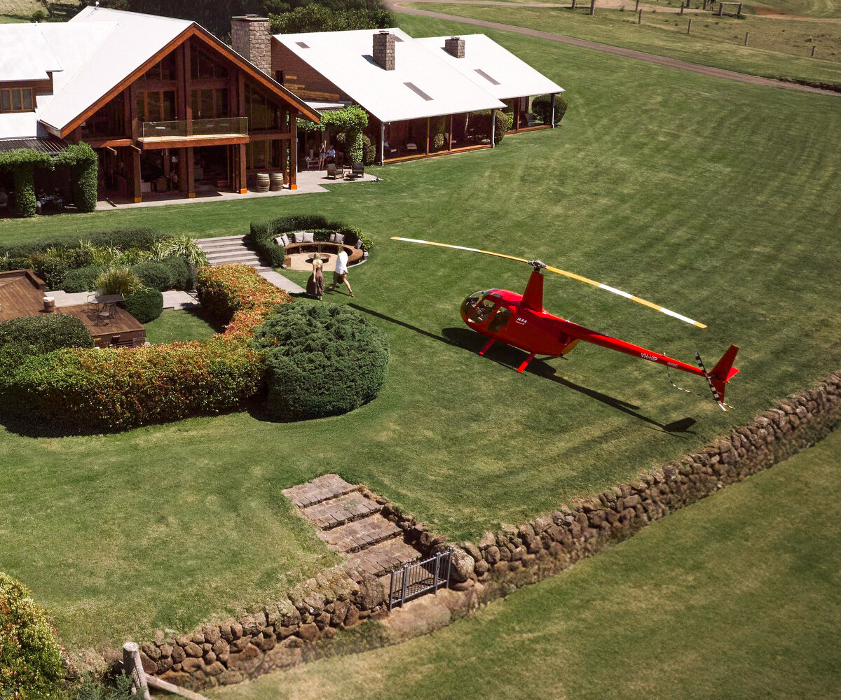 Aerial view of Spicers Peak Lodge with a Bekaa Air helicopter on the lawn