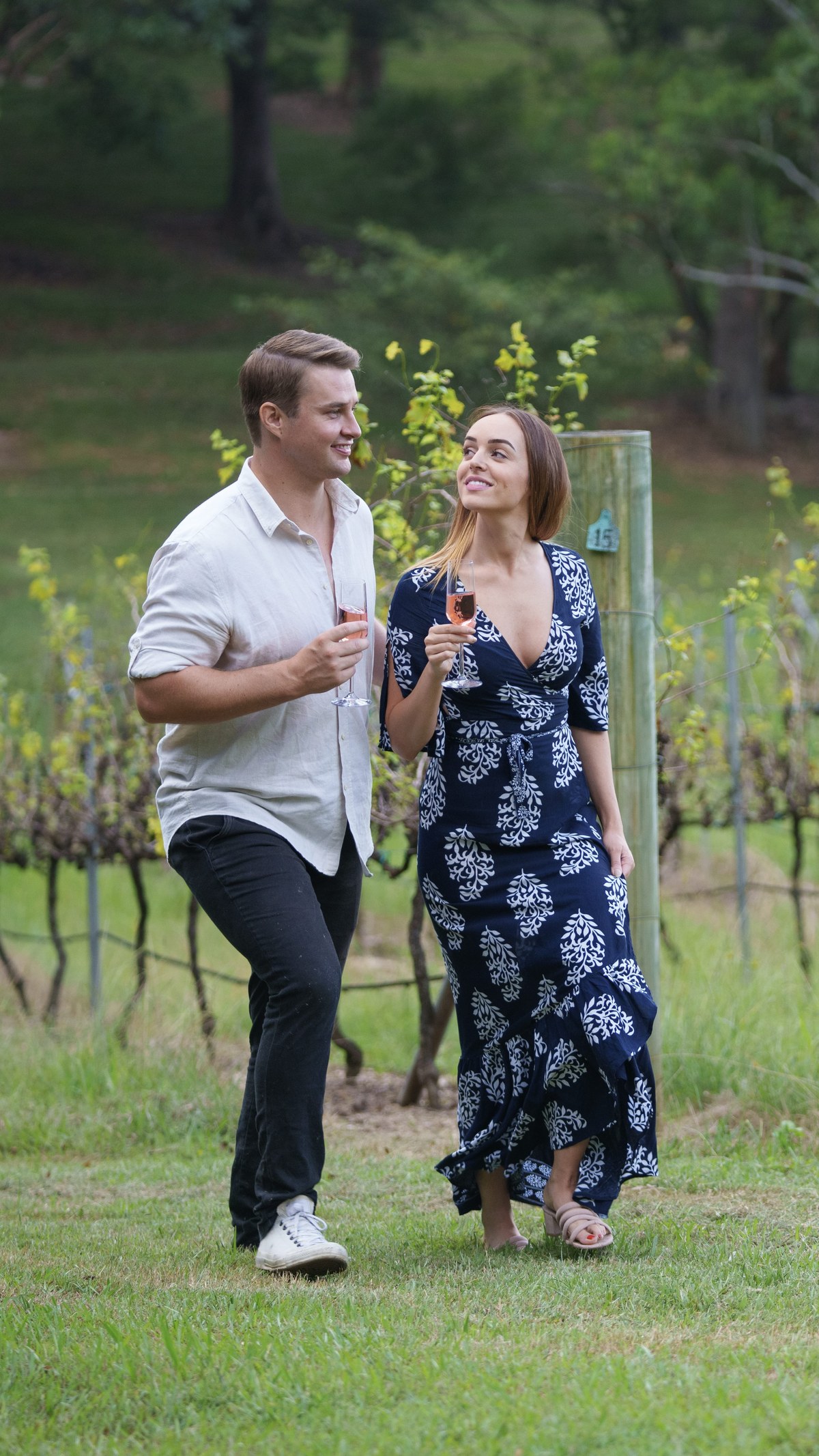 A couple enjoying wine in the Ocean View Estates vineyard.