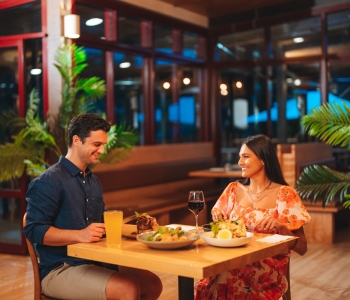 Couple enjoying a meal at Sand and Wood restaurant